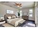 A beautifully staged bedroom featuring a ceiling fan and large windows at 14330 Channel Dr, Largo, FL 33774