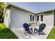 Outdoor patio with new concrete and modern chair seating, perfect for enjoying the backyard at 14330 Channel Dr, Largo, FL 33774