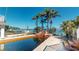 Backyard pool area with a waterfall feature leading to a serene waterfront view and dock at 15417 2Nd E St, Madeira Beach, FL 33708