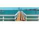 A wooden dock extends into the clear blue water under a sunny sky, great for relaxation at 15417 2Nd E St, Madeira Beach, FL 33708