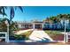 Charming single-story home with a balcony and landscaped walkway leading to the entrance at 15417 2Nd E St, Madeira Beach, FL 33708