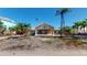 Inviting one-story home with a decorative front entrance, front lawn with palm trees, and blue skies at 15417 2Nd E St, Madeira Beach, FL 33708