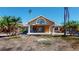 Inviting one-story home with a decorative front entrance, front lawn and palm trees at 15417 2Nd E St, Madeira Beach, FL 33708