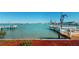 Scenic waterfront with a dock and serene views of the open water with cityscape in the distance at 15417 2Nd E St, Madeira Beach, FL 33708