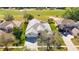 Stunning aerial view of a home overlooking a lush green golf course with a screened in pool at 18111 Diamond Cove Ct, Tampa, FL 33647