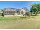 Expansive screened-in porch and lovely backyard provide plenty of space for outdoor gatherings at 18111 Diamond Cove Ct, Tampa, FL 33647