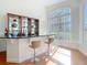 Wet bar area with granite countertops, display shelving, and seating for two at 18111 Diamond Cove Ct, Tampa, FL 33647