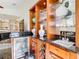 Wet bar with granite countertops, wine rack, mini fridge, and display shelves at 18111 Diamond Cove Ct, Tampa, FL 33647