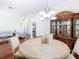 Formal dining room boasts wood floors, a chandelier, and space for a large table at 18111 Diamond Cove Ct, Tampa, FL 33647