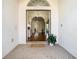Elegant foyer with hardwood floors, decorative columns, and an open layout that creates a seamless transition to the living spaces at 18111 Diamond Cove Ct, Tampa, FL 33647