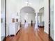 Bright foyer with hardwood flooring, stylish sideboard, and an inviting view into the home's spacious layout at 18111 Diamond Cove Ct, Tampa, FL 33647