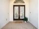 Inviting front entrance with brick pavers, glass doors and decorative transom window at 18111 Diamond Cove Ct, Tampa, FL 33647