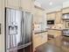 Gourmet kitchen with stainless steel appliances, stone counters, and cream colored cabinets at 18111 Diamond Cove Ct, Tampa, FL 33647