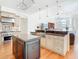 Open concept kitchen with stainless steel appliances, central island, and views of the living area at 18111 Diamond Cove Ct, Tampa, FL 33647