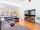 Spacious living room area with hardwood floors, comfortable leather couch and open to kitchen at 18111 Diamond Cove Ct, Tampa, FL 33647