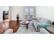 Comfortable living room with hardwood floors, a modern sofa, stylish decor, and access to the outdoor patio for relaxation at 18111 Diamond Cove Ct, Tampa, FL 33647
