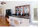 Living room bar with granite countertop and wooden display case at 18111 Diamond Cove Ct, Tampa, FL 33647