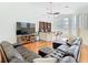 Bright living room with hardwood floors, large TV, and lots of seating at 18111 Diamond Cove Ct, Tampa, FL 33647