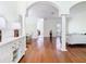Bright living room showcasing hardwood floors, columns and decorative arches at 18111 Diamond Cove Ct, Tampa, FL 33647