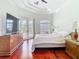 Bright main bedroom with hardwood floors, tray ceiling, and access to outdoor living at 18111 Diamond Cove Ct, Tampa, FL 33647