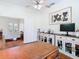 This office features hardwood floors, a ceiling fan, custom cabinets and a view to the living room at 18111 Diamond Cove Ct, Tampa, FL 33647