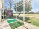 Screened patio with golf practice area overlooking the golf course offers relaxation and recreation at 18111 Diamond Cove Ct, Tampa, FL 33647