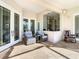 Neutral-colored patio with comfortable seating, stone floors, and kitchen access at 18111 Diamond Cove Ct, Tampa, FL 33647