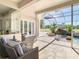 Inviting screened-in patio featuring comfortable seating and views of the private pool and waterfall at 18111 Diamond Cove Ct, Tampa, FL 33647