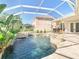 Beautiful backyard with lanai, sparkling pool, flowing waterfall feature and patio at 18111 Diamond Cove Ct, Tampa, FL 33647