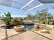 Stunning screened-in pool area with rock waterfall feature and integrated spa at 18111 Diamond Cove Ct, Tampa, FL 33647