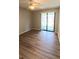 This bedroom has new wood floors, a ceiling fan, and sliding glass doors to a patio at 1822 Lake Cypress Dr # 1822, Safety Harbor, FL 34695