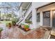 Inviting front entrance with brick walkway, flowers, and stairs leading to the second level unit at 1822 Lake Cypress Dr # 1822, Safety Harbor, FL 34695