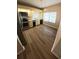 The kitchen features stainless appliances, wood floor, bright window, and neutral color palette at 1822 Lake Cypress Dr # 1822, Safety Harbor, FL 34695