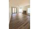 Large living room with fireplace, ceiling fan, wood flooring and sliding glass doors to the patio at 1822 Lake Cypress Dr # 1822, Safety Harbor, FL 34695