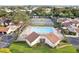 Aerial shot of a community pool and tennis courts surrounded by lush greenery and well-maintained buildings at 1881 N Hercules Ave # 1205, Clearwater, FL 33765
