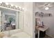 Bright bathroom with a vanity, mirror, and view of a home office space at 1881 N Hercules Ave # 1205, Clearwater, FL 33765