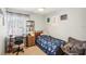 Comfortable bedroom featuring a desk area, a cozy chair, and a well-lit window at 1881 N Hercules Ave # 1205, Clearwater, FL 33765