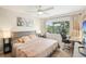 Elegant primary bedroom featuring a cozy bed, calming decor, a large window, and a functional study area at 1881 N Hercules Ave # 1205, Clearwater, FL 33765