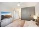 Primary bedroom with a spacious layout, walk-in closet, tv and ensuite bathroom at 1881 N Hercules Ave # 1205, Clearwater, FL 33765