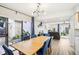 Open dining area with a wooden table, blue chairs, and view into a sunny outdoor patio at 1881 N Hercules Ave # 1205, Clearwater, FL 33765