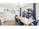 Inviting dining area with a light wood table, blue seating, and sliding glass doors to the patio at 1881 N Hercules Ave # 1205, Clearwater, FL 33765