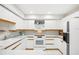Well-maintained kitchen featuring white cabinetry, modern appliances, and tile flooring at 1881 N Hercules Ave # 1205, Clearwater, FL 33765