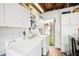 Functional laundry room with ample storage space, washer, dryer, and direct access to outdoor area at 1881 N Hercules Ave # 1205, Clearwater, FL 33765