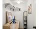 Cozy office space featuring a modern desk with laptop, floating shelves, and stylish decor at 1881 N Hercules Ave # 1205, Clearwater, FL 33765