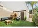 Cozy patio area with artificial grass, playhouse, and comfortable seating, shaded by a large awning at 1881 N Hercules Ave # 1205, Clearwater, FL 33765