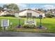 Community sign for Sunset Grove with unit numbers and a manicured lawn, offering a welcoming entrance at 1881 N Hercules Ave # 1205, Clearwater, FL 33765