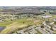 Aerial view of a community with a golf course, ponds, and lush greenery, highlighting the scenic surroundings at 2022 Heathfield Cir, Sun City Center, FL 33573