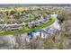 Beautiful aerial view of homes along a lake, creating a peaceful and picturesque community setting at 2022 Heathfield Cir, Sun City Center, FL 33573