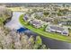 An aerial view of homes nestled along a winding lake, offering scenic waterfront living at 2022 Heathfield Cir, Sun City Center, FL 33573
