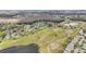 An aerial shot showcasing a community surrounded by a golf course, ponds, and a lush green landscape at 2022 Heathfield Cir, Sun City Center, FL 33573